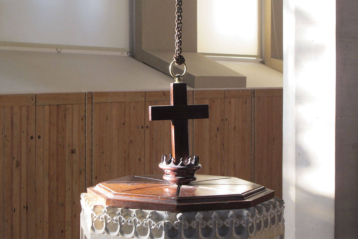 Horsley Church baptismal font cross detail with timber panelling and daylight